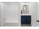 This primary bathroom boasts a modern vanity with gold hardware and a shower-tub combo at 5705 Dean Ave, Raleigh, NC 27616