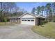 Charming brick home with a spacious driveway and an attached two-car garage at 5705 Dean Ave, Raleigh, NC 27616