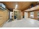 Spacious garage with wood paneling, storage cabinets, and space for multiple vehicles or workshop area at 5705 Dean Ave, Raleigh, NC 27616