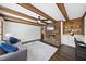 Cozy living room boasts a brick fireplace, wooden beams, and comfortable seating at 5705 Dean Ave, Raleigh, NC 27616