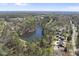 Expansive aerial view of neighborhood pond surrounded by trees, highlighting community nature and amenities at 5705 Dean Ave, Raleigh, NC 27616