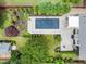 Aerial view showcasing a rectangular pool, lush landscaping, and a manicured backyard at 5811 Shawood Dr, Raleigh, NC 27609