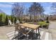 Inviting patio features an outdoor table, Adirondack chairs, and a lush, well-manicured lawn at 5811 Shawood Dr, Raleigh, NC 27609