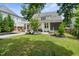 Lush green backyard with a pool, patio, mature trees, and well-manicured landscaping at 5811 Shawood Dr, Raleigh, NC 27609