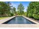 An amazing backyard featuring an inviting swimming pool and pristine landscaping at 5811 Shawood Dr, Raleigh, NC 27609