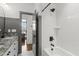 Modern bathroom with subway tile, a shower-tub combo, and sleek black fixtures at 5811 Shawood Dr, Raleigh, NC 27609