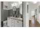 Elegant bathroom featuring double vanities, marble countertops, decorative mirrors, and stylish fixtures at 5811 Shawood Dr, Raleigh, NC 27609