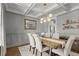 Elegant dining room features coffered ceilings, wainscoting, and stylish light fixture at 5811 Shawood Dr, Raleigh, NC 27609