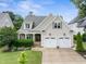 Charming home with a two-car garage, manicured lawn, and inviting front entrance at 5811 Shawood Dr, Raleigh, NC 27609