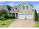 Charming home with a two-car garage, well-manicured lawn, and stone-accented entry at 5811 Shawood Dr, Raleigh, NC 27609