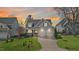Charming two-story home with a manicured front yard, two-car garage and sunset sky at 5811 Shawood Dr, Raleigh, NC 27609