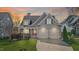Charming home featuring a two-car garage, and well-maintained landscaping, at sunset at 5811 Shawood Dr, Raleigh, NC 27609