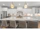 Spacious kitchen island with seating, modern pendant lights, and ample countertop space at 5811 Shawood Dr, Raleigh, NC 27609