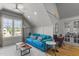 Bright living room with a large window, cozy blue sofa, and hardwood floors at 5811 Shawood Dr, Raleigh, NC 27609