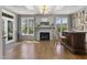 Inviting living room features a fireplace, a built in bar, and large windows that let in natural light at 5811 Shawood Dr, Raleigh, NC 27609
