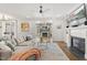 Bright living room with hardwood floors, fireplace, and seamless flow to dining area at 5811 Shawood Dr, Raleigh, NC 27609