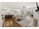 Expansive open-concept living area featuring hardwood floors, a comfortable sofa, and a modern fireplace at 5811 Shawood Dr, Raleigh, NC 27609