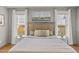 This is a king bed in a large bedroom with a sitting area, neutral decor, and bright natural light at 5811 Shawood Dr, Raleigh, NC 27609