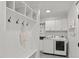 Mudroom with storage cubbies, hooks, bench, and a nearby laundry area with a washer and dryer at 5811 Shawood Dr, Raleigh, NC 27609