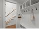 Entryway mudroom with storage cubbies, hooks, a built-in bench, and a staircase leading to the upper level at 5811 Shawood Dr, Raleigh, NC 27609