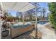 Covered outdoor patio with stylish furniture and a view of the pool at 5811 Shawood Dr, Raleigh, NC 27609