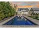 Stunning backyard pool with lounge chairs and manicured landscaping, perfect for outdoor relaxation and entertainment at 5811 Shawood Dr, Raleigh, NC 27609