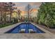 A luxurious backyard pool with stylish lounge chairs and lush landscaping for ultimate relaxation at 5811 Shawood Dr, Raleigh, NC 27609