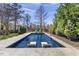 Stunning in-ground pool surrounded by lush landscaping and lounge chairs at 5811 Shawood Dr, Raleigh, NC 27609