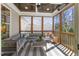 Relaxing screened porch with comfortable seating, ceiling fan, and natural light at 5811 Shawood Dr, Raleigh, NC 27609