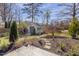 Backyard shed with charming details, nestled among mature trees and greenery at 5811 Shawood Dr, Raleigh, NC 27609