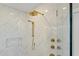 Elegant shower featuring herringbone tiling, gold hardware, and a built-in niche for convenience at 5811 Shawood Dr, Raleigh, NC 27609