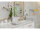Bathroom vanity featuring white countertops, gold fixtures, and a decorative orchid at 5811 Shawood Dr, Raleigh, NC 27609