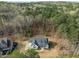 An aerial shot of a home nestled among mature trees, highlighting its landscaped yard and proximity to natural woodland at 76 Gentry Dr, Pittsboro, NC 27312