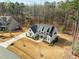 Aerial view of a modern farmhouse-style home with a well-manicured front yard and a long driveway at 76 Gentry Dr, Pittsboro, NC 27312