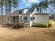 The house features a screened porch, an open deck area, and a well-maintained backyard space with lush greenery at 76 Gentry Dr, Pittsboro, NC 27312