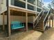 Wonderful backyard features a porch swing beneath the deck and stairway access to a raised screened in porch at 76 Gentry Dr, Pittsboro, NC 27312
