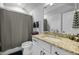 Clean bathroom with a granite counter, white vanity, and shower curtain at 76 Gentry Dr, Pittsboro, NC 27312