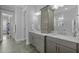 Bathroom with double vanity, marble countertop, storage cabinets and view to a closet at 76 Gentry Dr, Pittsboro, NC 27312