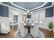 Open dining room with elegant lighting fixture, large windows and view to sitting room and front door at 76 Gentry Dr, Pittsboro, NC 27312