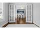 Open dining room with elegant lighting fixture and white wainscoting with blue accent paint at 76 Gentry Dr, Pittsboro, NC 27312