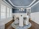 Dining room featuring a modern chandelier, large windows, and a stylish blue and white rug at 76 Gentry Dr, Pittsboro, NC 27312