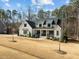 Gorgeous two-story home with manicured lawn, basketball hoop, and a welcoming porch at 76 Gentry Dr, Pittsboro, NC 27312