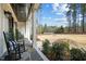 Cozy front porch with black rocking chairs and view of the landscaped front yard at 76 Gentry Dr, Pittsboro, NC 27312