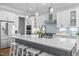 Well-lit kitchen offers a granite island with seating and state-of-the-art stainless steel appliances at 76 Gentry Dr, Pittsboro, NC 27312