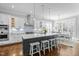 Open kitchen boasts a large island with seating, modern appliances, and an adjacent dining area at 76 Gentry Dr, Pittsboro, NC 27312