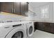 Well-equipped laundry room with modern washer and dryer and plenty of cabinets at 76 Gentry Dr, Pittsboro, NC 27312