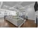 Open concept living room with a modern sofa, sleek ceiling design, and bright kitchen at 76 Gentry Dr, Pittsboro, NC 27312