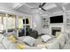 Comfortable living room with a fireplace, large sectional sofa, and sliding doors to the patio at 76 Gentry Dr, Pittsboro, NC 27312