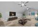 Bright living room with neutral decor, large TV, and comfortable seating at 76 Gentry Dr, Pittsboro, NC 27312