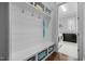 Mud room with bench, hooks, and shelves; laundry room is visible beyond at 76 Gentry Dr, Pittsboro, NC 27312